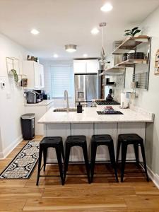 a kitchen with a large counter with four stools at Luxe On Walnut/King Bed/Off St.Parkin/30 days stay in Lancaster