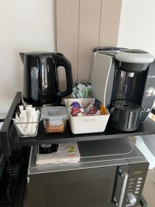 a counter with a coffee maker on top of a appliance at Willow Mews in Swansea