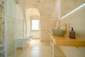 a bathroom with a sink and a shower and a toilet at Palazzo Gentile in Locorotondo +57 photos