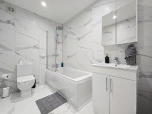 een witte badkamer met een toilet en een wastafel bij DYSA Bond Apartments in Blackpool
