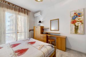 a bedroom with a bed and a desk and a window at Giaely in Borghetto Santo Spirito +37 photos