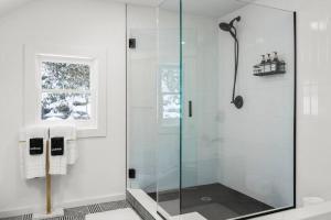 a shower with a glass door in a bathroom at Hudson Valley and The Berkshires Cottage in Hillsdale +13 photos