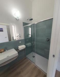 a bathroom with a glass shower and a sink at The Stunning B&B in Peschici