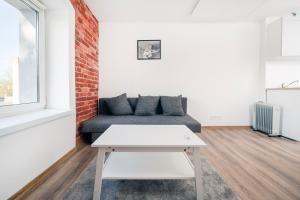 a living room with a couch and a table at Nawrot Cosy Studio in Łódź