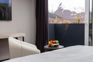 a bowl of fruit on a table next to a window at Morea Hotel in Prizren