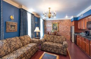 a living room with a couch and a table at Quarter House Suites in New Orleans