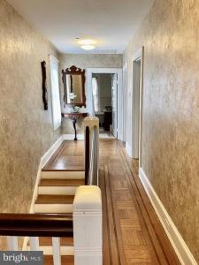 a hallway with a staircase in a house at Vintage Charm: Annapolis Retreat in Annapolis