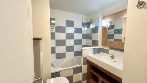 a bathroom with a sink and a toilet at Argousiers 107 in Fort-Mahon-Plage +3 photos