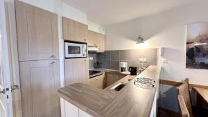 a kitchen with a counter and a sink in it at Argousiers 107 in Fort-Mahon-Plage