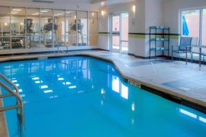 a large swimming pool with blue water at Fairfield Inn & Suites by Marriott Mobile Daphne/Eastern Shore in Spanish Fort