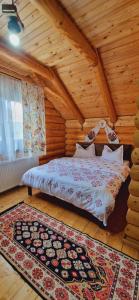 a bedroom with a bed in a wooden room at Casa Ilies in Rozavlea