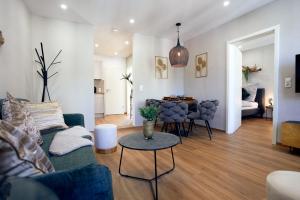 a living room with a couch and a table at LIVING Apartments / FeWo Neuwied in Neuwied