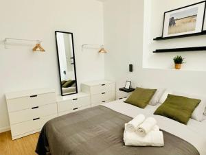 a bedroom with a large bed with towels on it at Chic & Stylish Madrid Hideout in Madrid