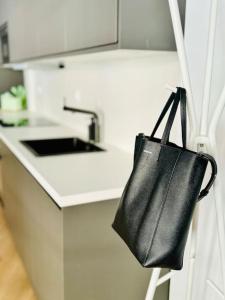 a black purse hanging on a kitchen counter at Chic & Stylish Madrid Hideout in Madrid