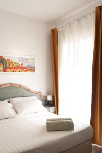 a bedroom with a bed and a window at Hotel Terme Oriente - Beach & SPA in Ischia