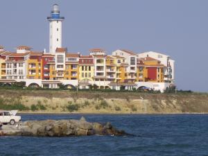 a large building with a lighthouse in the background at STUDIO DELUXE IN MARINA CAPE 4 stars complex 33 7 in Aheloy