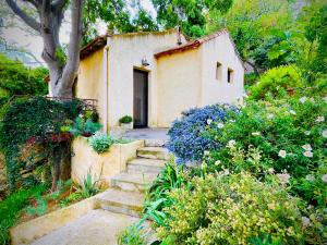 a small house with stairs leading up to it at Maison, centre ville, terrasse, parking, calme in Sète