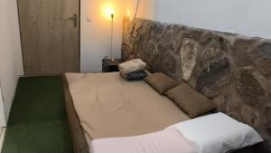 a bed in a room with a stone wall at Casa El Drago in Las Palmas de Gran Canaria