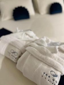 a close up of two white towels on a bed at Hotel Motel Top in Cusago