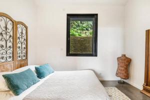 a bedroom with a bed and a window at Maison, centre ville, terrasse, parking, calme in Sète
