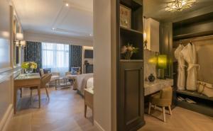 a hotel room with a bed and a dining room at The Brehon Hotel & Spa in Killarney