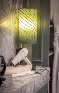 a phone on a table with a lamp on it at The Brehon Hotel & Spa in Killarney