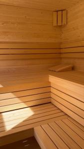 a wooden sauna with wooden flooring and a wooden at W Brzozowym Gaju Lubiatowo in Lubiatowo