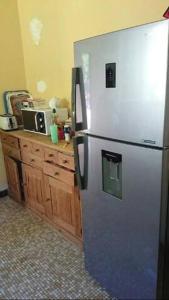 a stainless steel refrigerator in a kitchen with a counter at Le Chalet du Moulin Blanc in Bergerac