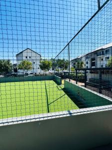 a tennis court with a net on top of it at Urban Oasis Retreat in Midrand
