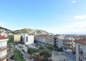 a city with cars parked in a parking lot at RNET-Nautilus Roses Costa Brava in Roses
