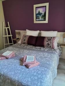 a bedroom with a bed with two bags on it at Villa Entre Bordeaux et Arcachon in Salles +32 photos
