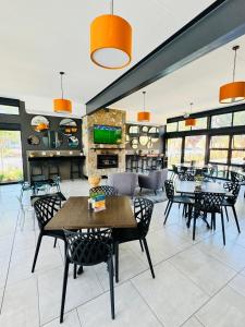 a dining room with tables and chairs in a building at Urban Oasis Retreat in Midrand