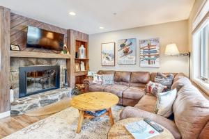 a living room with a couch and a fireplace at Vantage Point #8 in Stratton
