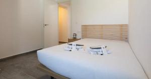 a white bed in a room with two glasses on it at Top2Stay Los Rosales in Torremolinos