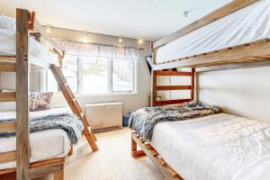 a bedroom with two bunk beds and a window at Vantage Point #8 in Stratton