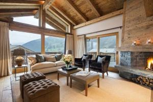 a living room with a couch and a fireplace at Luxury Apartment in Crans Montana by Dieckereise in Crans-Montana
