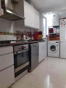 a kitchen with a stove and a washer and dryer at Castellón in Castellón de la Plana