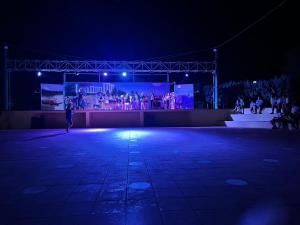 a person flying a kite on a stage at night at Villaggio Mondial Camping in Metaponto