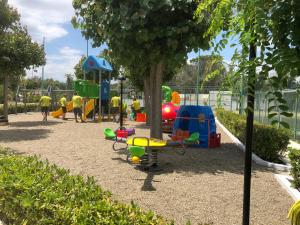 a playground with children playing in a park at Villaggio Mondial Camping in Metaponto