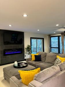 a living room with a couch and a tv at Saugerties Modern Charm with Creekside access and views in Saugerties