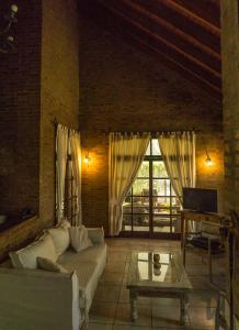 a living room with a couch and a table at Ruca Luma B&B - Chacras in Ciudad Lujan de Cuyo