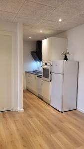 a kitchen with white appliances and a white refrigerator at Lego Fans Аpartment #1 in Billund Center in Billund