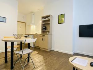 a kitchen and dining room with a table and chairs at Chez PISTACHE in Rodez