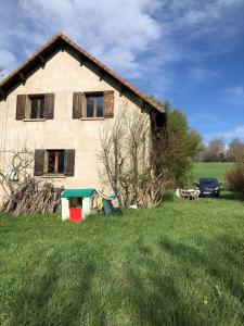 a house in the middle of a green field at Grand chalet familial in Forest-Saint-Julien