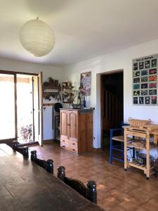 a living room with a table and a kitchen at Grand chalet familial in Forest-Saint-Julien