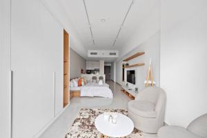 a bedroom with a bed and a living room at Spacious and Cozy Apartment in Dubai