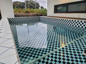 a pool in a house with a tiled floor at Green Casa in Hwasul-li