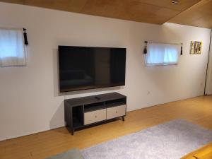 a living room with a flat screen tv on the wall at Green Casa in Hwasul-li