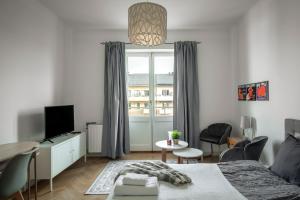 a bedroom with a bed and a tv and a window at Libevi 1 in Stockholm