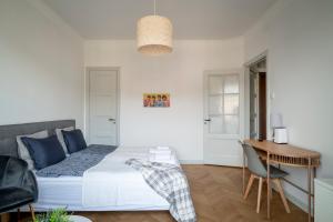 a bedroom with a bed and a table and a desk at Libevi 1 in Stockholm